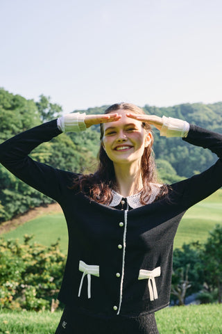 FAIRLIAR 26SS editorial - black cardigan with lace collar, pearl buttons and ribbon details